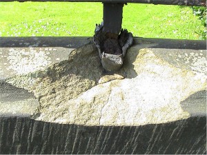 Coping stone destroyed by corroding wrought iron